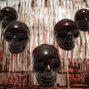 Black skull ornaments hanging from chains.