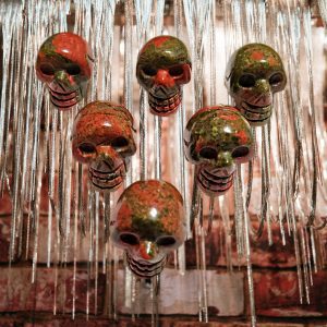 Six red and green skull pendants.