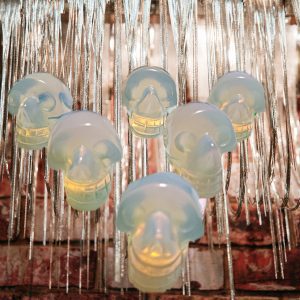 Six glowing skull ornaments hanging.