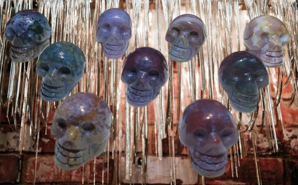 Stone skull pendants hanging from chain.