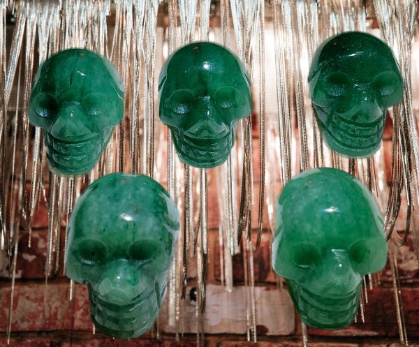 Five green jade skull pendants.