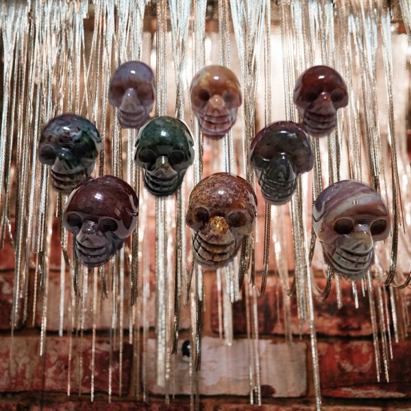 Stone skull charms hanging on silver chains.