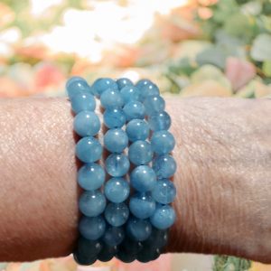 Aquamarine beaded bracelet on a wrist.