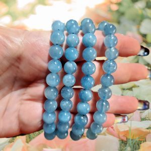 Aquamarine beaded bracelets on hand.