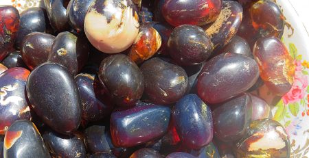 A bowl filled with Sumatra Blue Amber Tumbles.