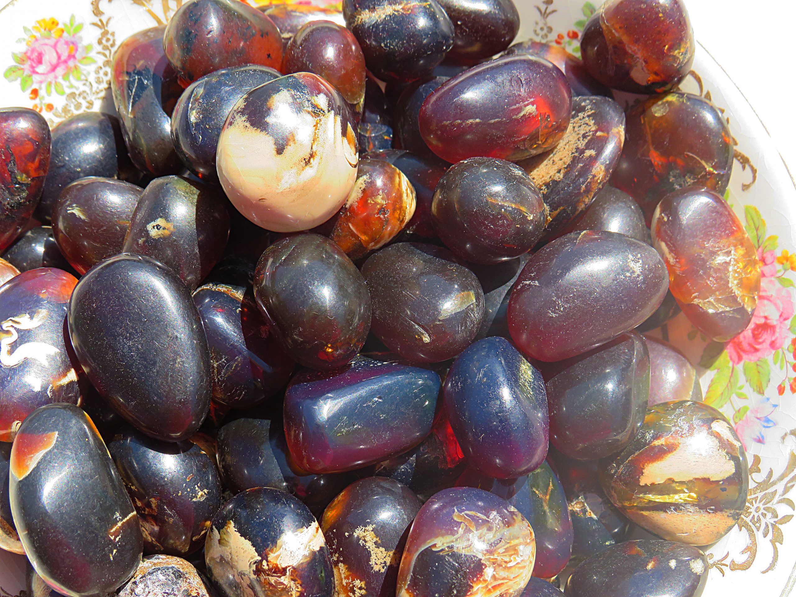 A bowl filled with Sumatra Blue Amber Tumbles.