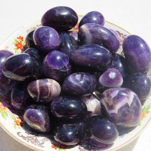 Amethyst stones on a floral plate.