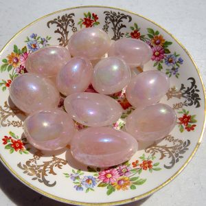 Pink iridescent stones on a floral plate.