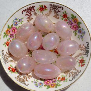 Pink iridescent stones on a floral plate.