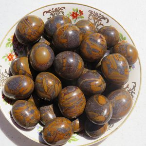 Brown and gold patterned stones in a bowl.