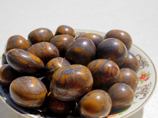 Polished brown and gray stones in a bowl.