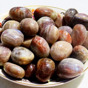 Sunstone tumbled stones in a bowl.