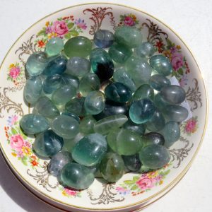 Green fluorite stones on a floral plate.