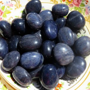 Smooth blue stones on a floral plate.