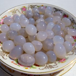 White agate stones on a patterned plate.