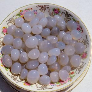 White agate stones in a floral bowl.