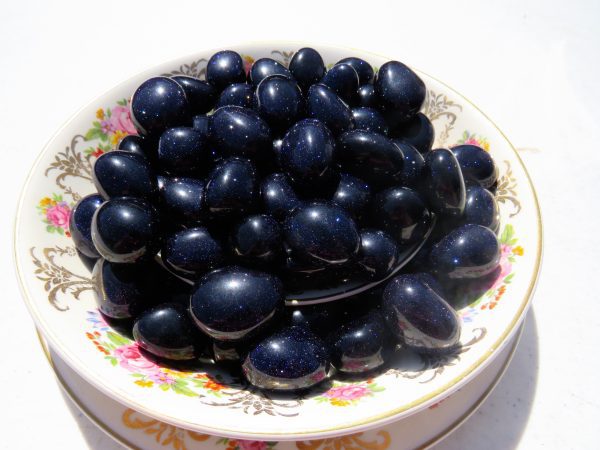 Blue sunstone tumbled stones in a bowl.
