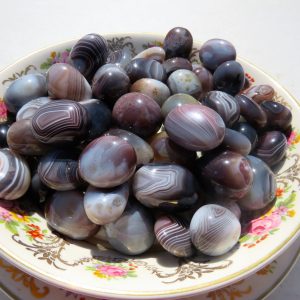 Striped agate stones on a floral plate.