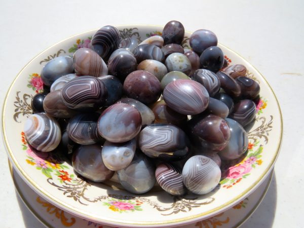 Striped agate stones on a floral plate.