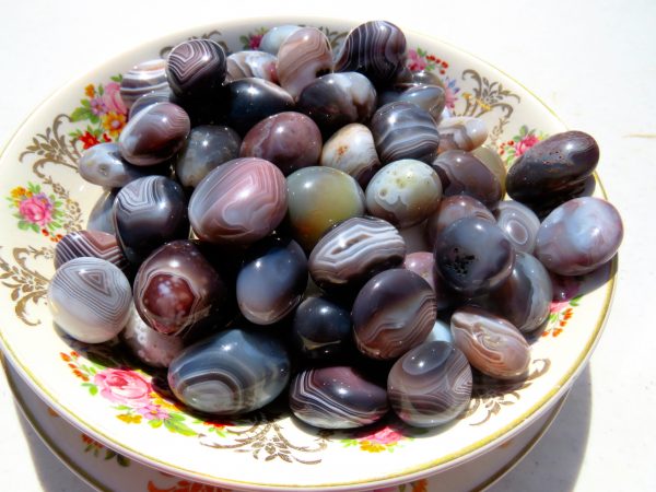 Banded agate stones on a floral plate.