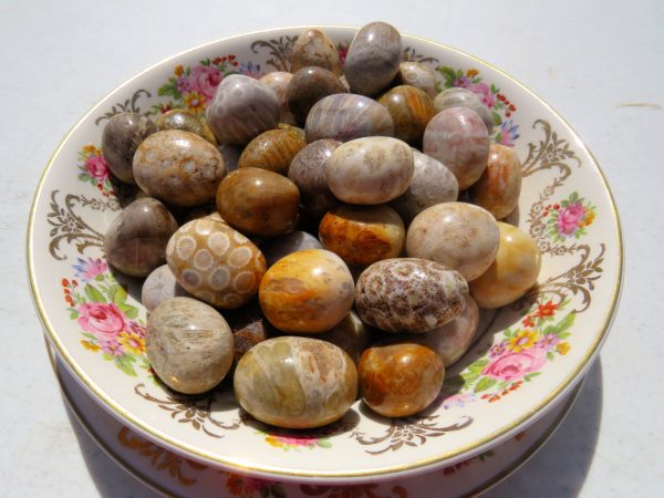 Polished stones on a floral plate.