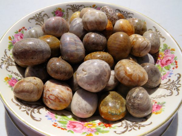 Polished stones on a floral plate.