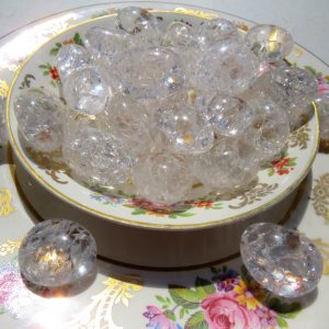 Clear quartz crystals on a floral plate.