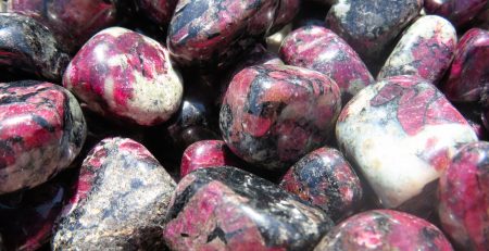 A pile of pink and black piedras preciosas.