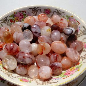 Pink and orange agate stones in a bowl.