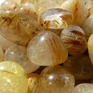 A pile of rutilated quartz gemstones.