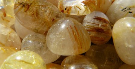 A pile of rutilated quartz gemstones.