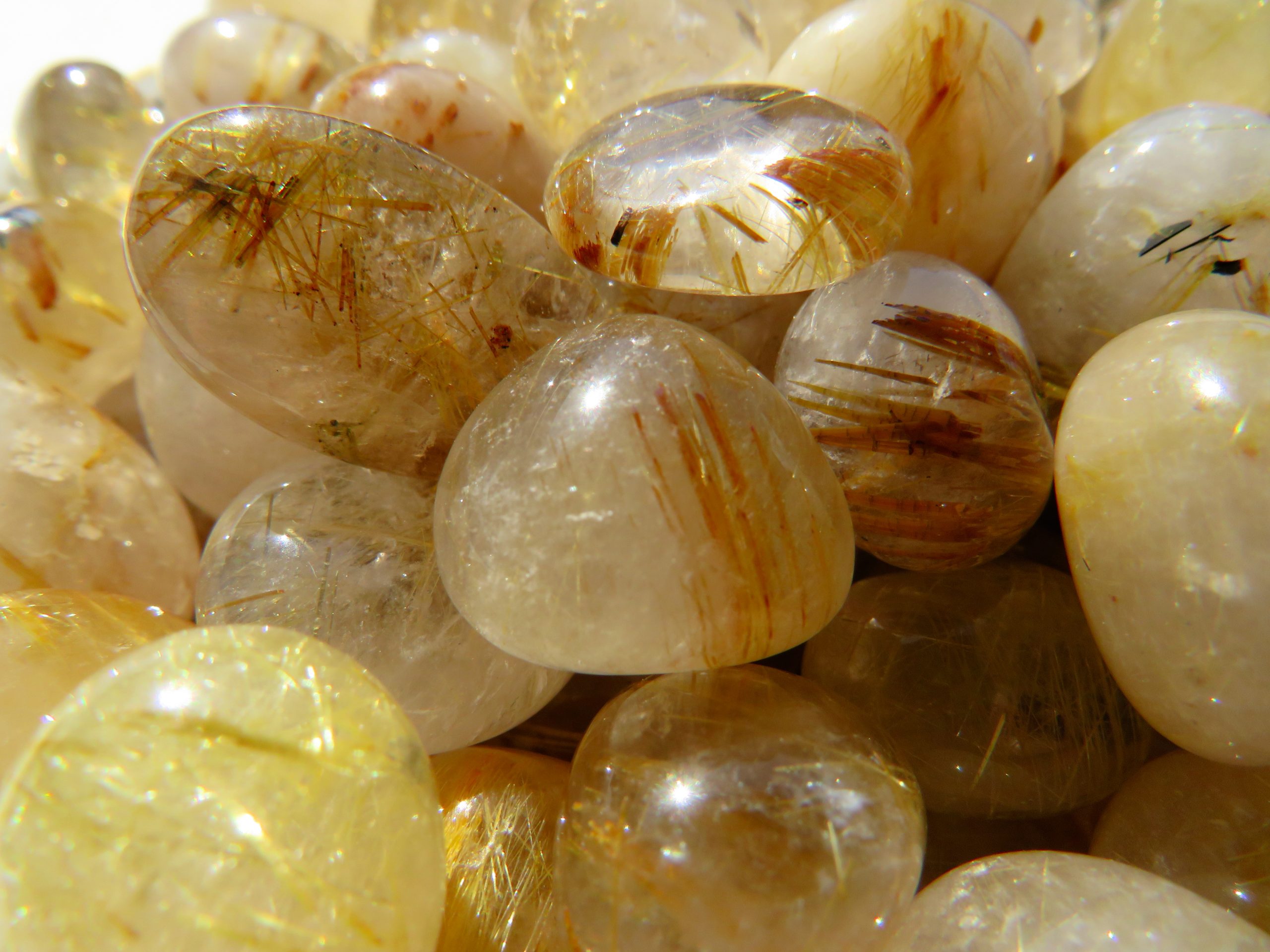 A pile of rutilated quartz gemstones.