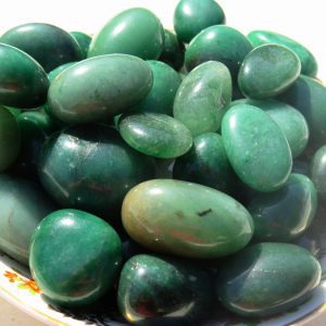 Green aventurine tumbled stones in bowl.