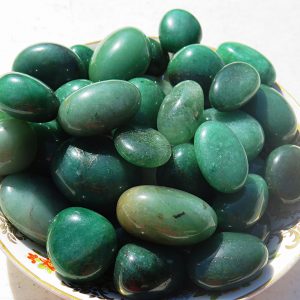 Green gemstone tumbled stones in a bowl.