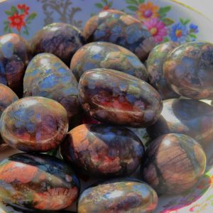 Polished stones in a floral dish.