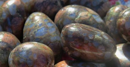 Close up of a pile of shiny polished rocks.