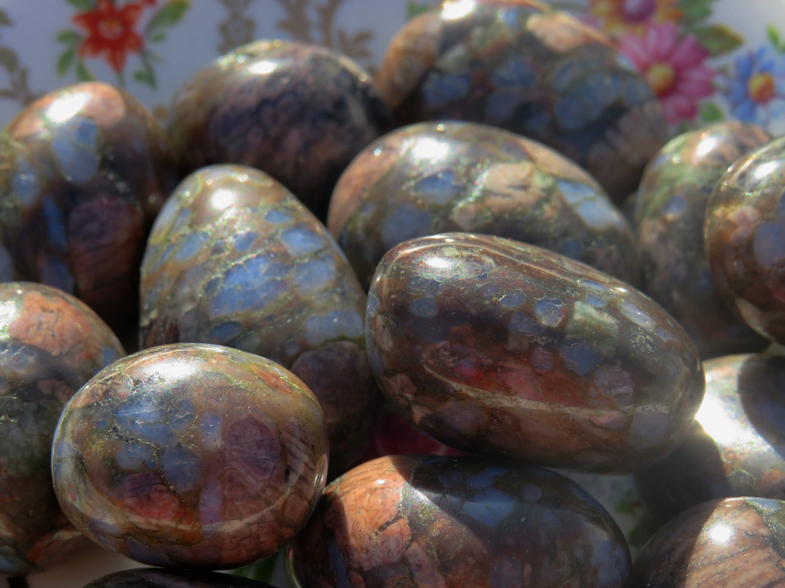 Close up of a pile of shiny polished rocks.