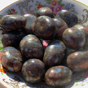 Polished stones on a floral plate.