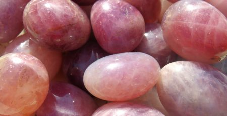 A bowl of Lavender Rose Quartz Tumbles in a floral pattern.