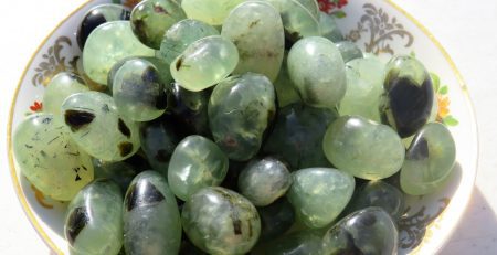 Green and black stones in a bowl.