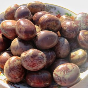 Brown and white tumbled stones in a bowl.