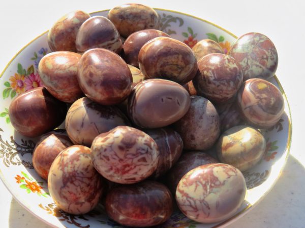 Brown and white striped stones in a bowl.