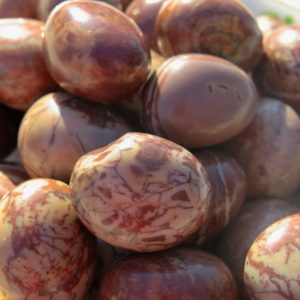 Close-up of smooth, red and white stones.