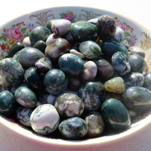 Green and white agate stones in a bowl.