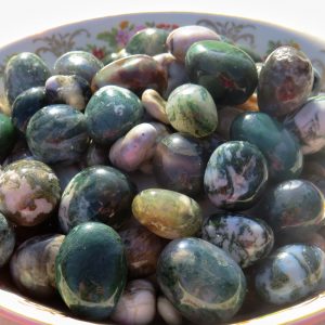 Green and white agate tumbled stones in bowl.