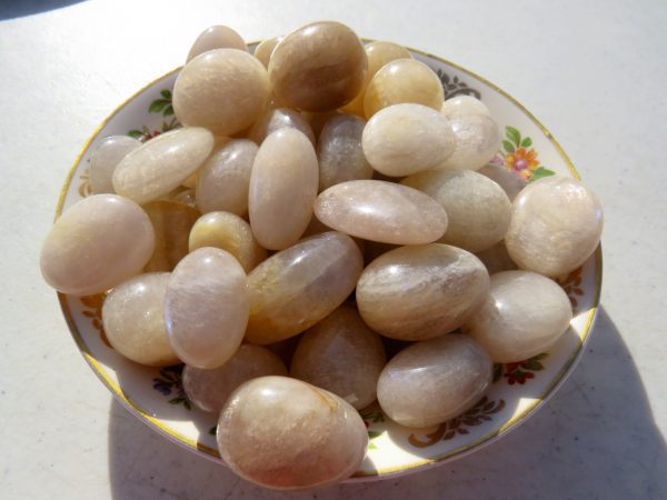 Pile of smooth white stones in a bowl.