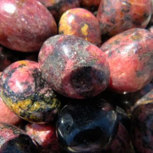 Pink and black polished gemstone tumbled stones.