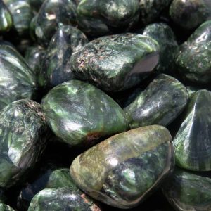 Green gemstone tumbled stones close up.