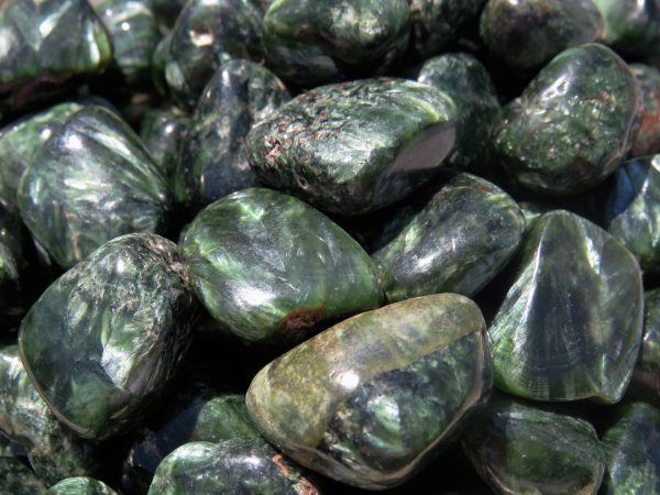 Green gemstone tumbled stones close up.