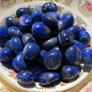 Blue and gold lapis lazuli stones on a plate.